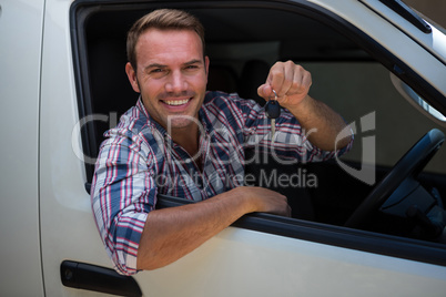 Young man showing car keys