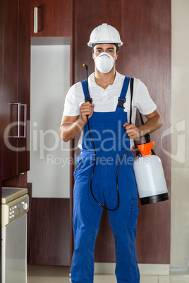 Man doing pest control in kitchen
