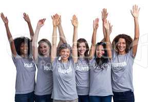 Portrait of happy volunteers standing with hands raised