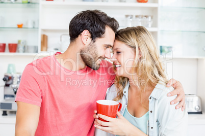 Young couple holding coffee mug