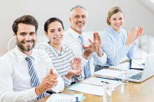 Business colleagues applauding in a meeting