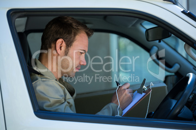 Delivery man sitting in his van