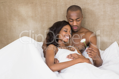 Young man offering a flower to woman