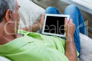 High angle view on senior man with tablet pc