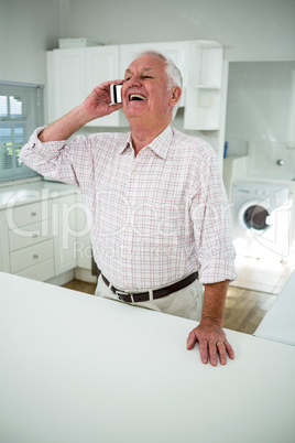 Happy senior man talking on mobile phone