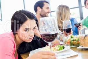 Drunk woman looking at wine glass