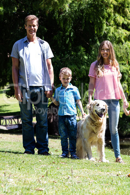 Happy family standing in the park