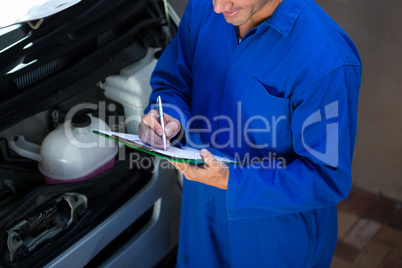 Mechanic preparing a check list