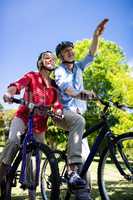 Senior couple standing with bicycle