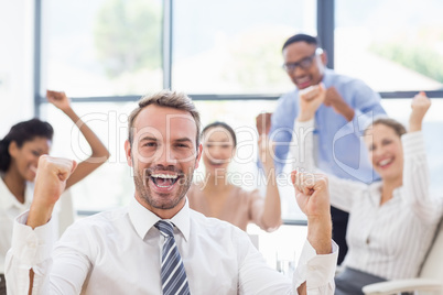 Portrait of businessman celebrating success with her colleagues