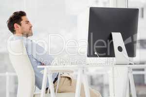 Businessman sitting with arms crossed in the office