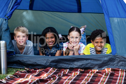 Children lying in a tent