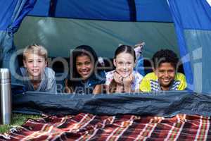Children lying in a tent