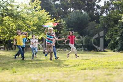 Happy children playing with a kite