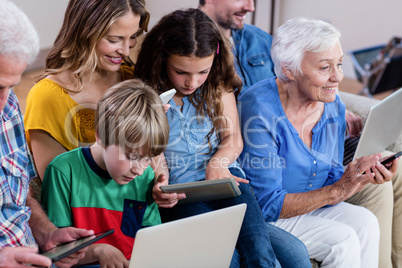 Multi-generation family using a laptop, tablet and phone