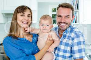 Happy parents with baby boy at home