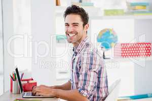Young man using laptop at his desk