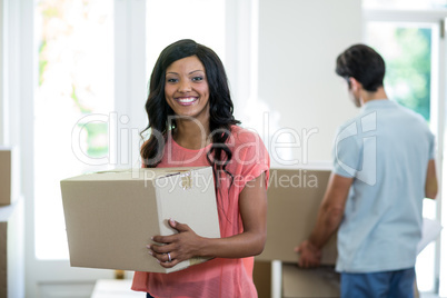 Young couple carrying cardboard box