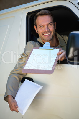 Smiling delivery man sitting in his van