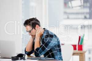 Stressed young man sitting at his desk