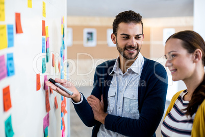 Colleagues looking at white board