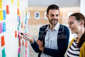 Colleagues looking at white board