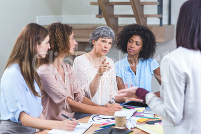 Woman giving presentation to her colleagues