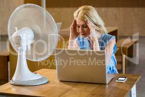 Tense woman sitting in desk