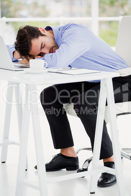 Businessman Putting His Head Down On Desk Royalty Free Images
