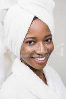 Happy young woman wearing white bathrobe