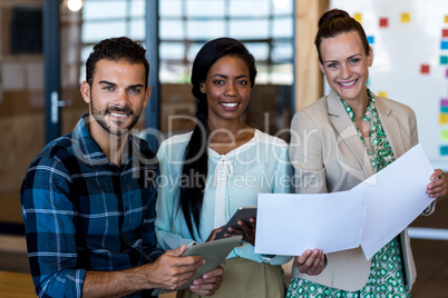 Young man and women discuss using digital tablet and document