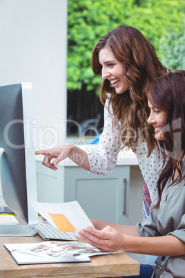 Two beautiful woman using computer