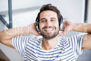 Man relaxing and listening to music on headphone