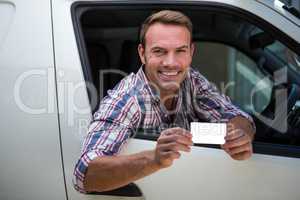 Young man showing his drivers license