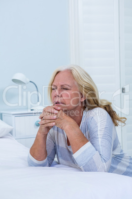 Woman praying in bedroom