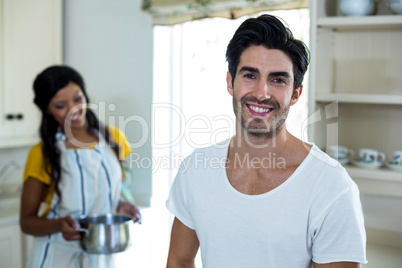 Happy couple preparing food in kitchen