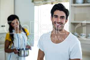 Happy couple preparing food in kitchen