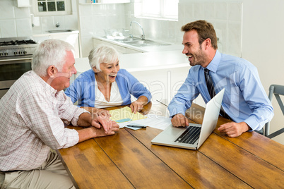 Couple laughing with agent sitting at table