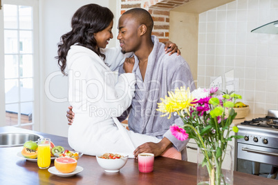 Young couple cuddling in the kitchen