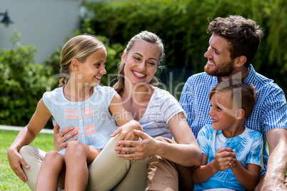 Happy family enjoying while sitting in yard