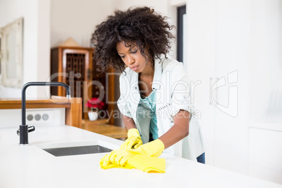 Woman cleaning kitchen counter