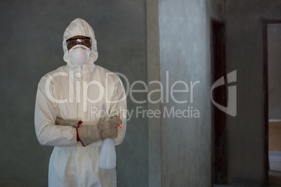 Pest control man standing with spray bottle