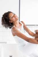 Happy young woman in bathroom