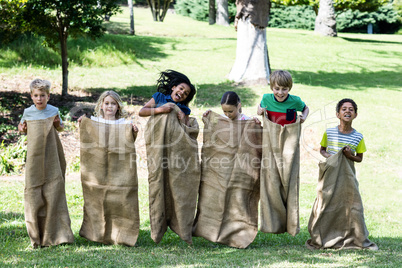 Children having a sack race in park