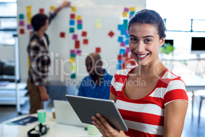 Young woman holding digital tablet