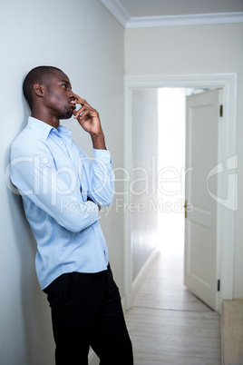 Tensed man leaning on wall