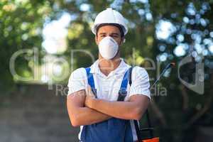 Portrait of confident pesticide worker with arms crossed