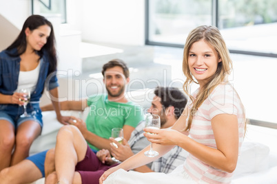 Two cute couple smiling with alcohol glass in hand