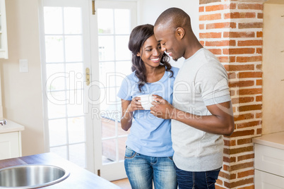 Young couple holding coffee mug