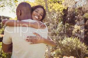 Young couple hugging in park